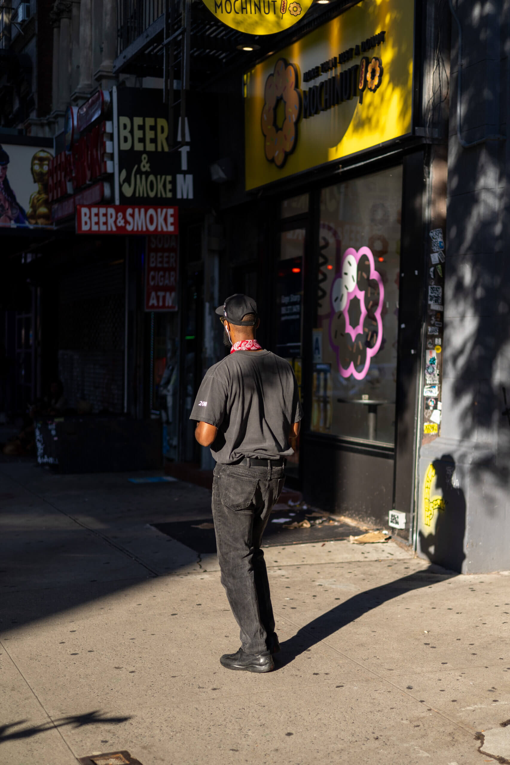 A photo of a stylishly dressed man standing near a vintage store on the streets of New York, blending urban fashion with timeless charm