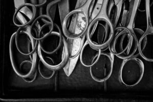 A photo of several scissor handles arranged at the Annecy braderie, showcasing intricate vintage designs and craftsmanship