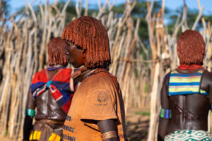A photo of Hamar women in Ethiopia revealing fresh whip scars during the bull-jumping ceremony, symbolizing strength and commitment in their tradition