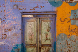 A vibrant violet and yellow door in Aswan, Egypt, showcasing colorful Nubian architecture